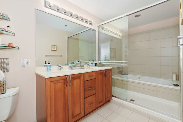 full bathroom featuring enclosed tub / shower combo, tile patterned floors, toilet, and vanity