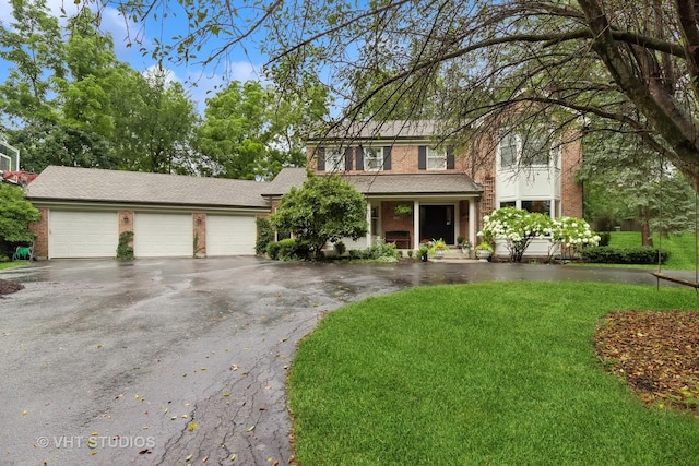 view of front of property featuring a garage and a front lawn