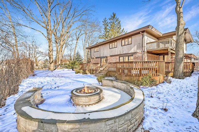 exterior space with a deck and a fire pit