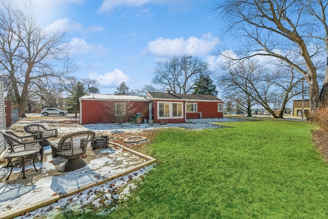 rear view of property featuring a lawn