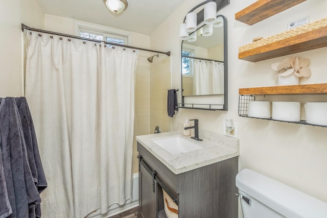 full bathroom featuring shower / bathtub combination with curtain, vanity, and toilet