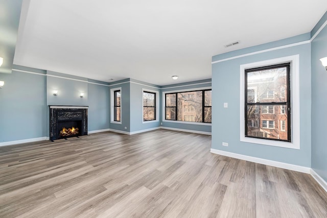 unfurnished living room with light hardwood / wood-style floors