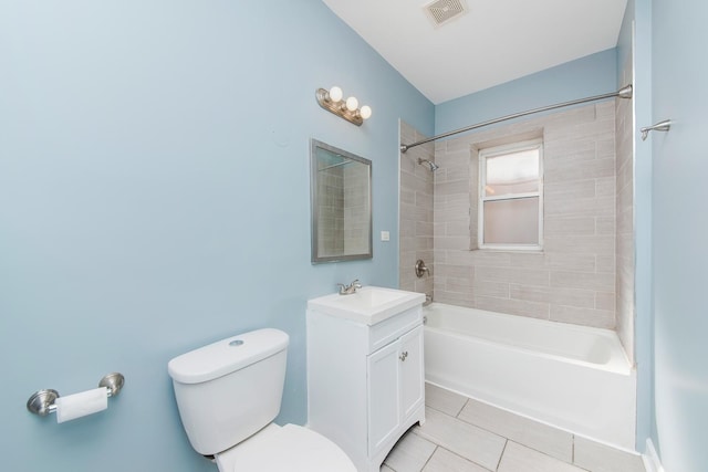 full bathroom featuring vanity, toilet, tiled shower / bath combo, and tile patterned flooring