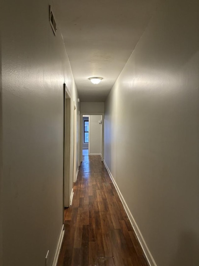 corridor with dark wood-type flooring