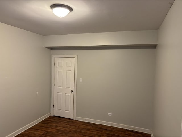 spare room with dark hardwood / wood-style floors