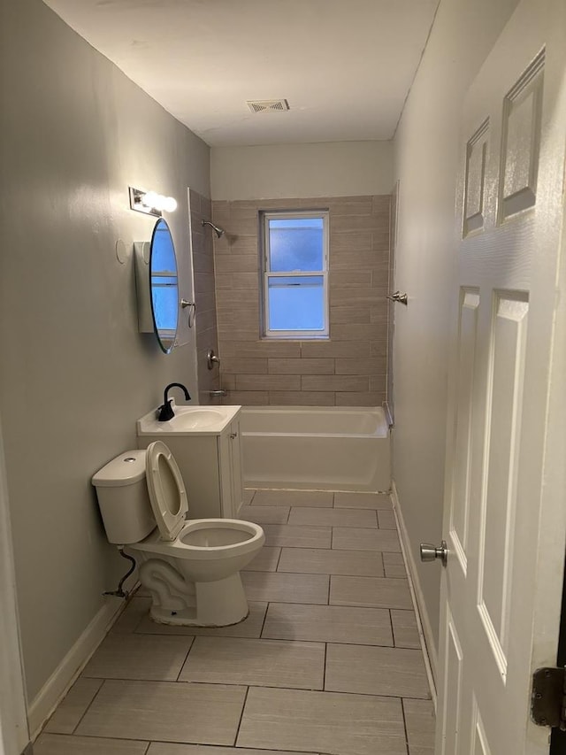 full bathroom with vanity, tiled shower / bath combo, and toilet