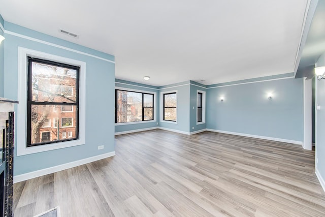 unfurnished living room with light wood-type flooring