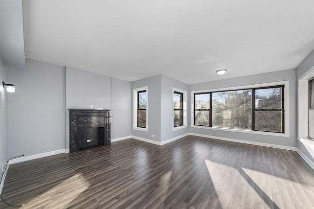 unfurnished living room with dark wood-type flooring