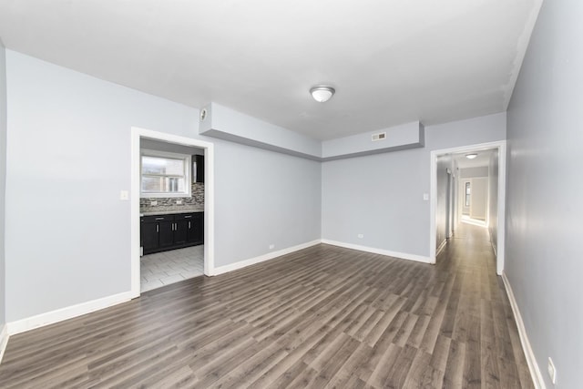 unfurnished room with dark hardwood / wood-style floors