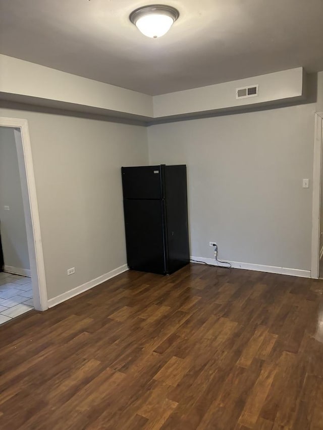 unfurnished room with dark hardwood / wood-style flooring