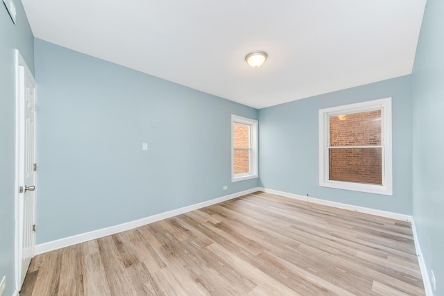 unfurnished room with light hardwood / wood-style flooring