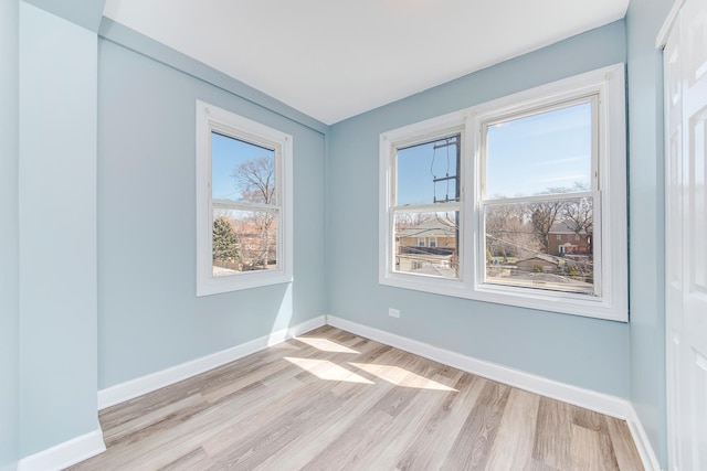 empty room with light hardwood / wood-style flooring