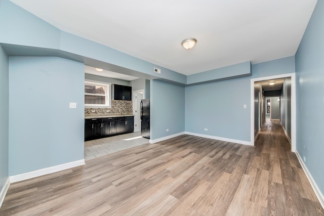 unfurnished living room with light hardwood / wood-style floors