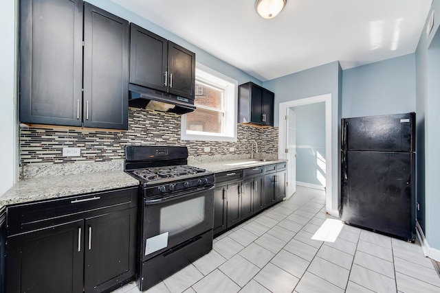 kitchen featuring light tile patterned floors, sink, tasteful backsplash, light stone countertops, and black appliances