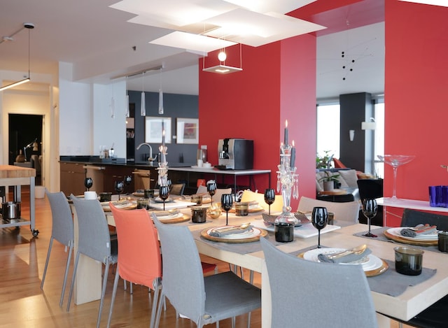 dining area featuring sink and wood-type flooring