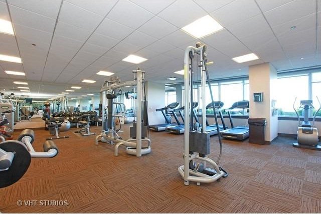 gym with plenty of natural light and carpet floors