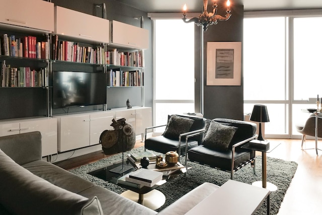 living room featuring a wall of windows, a healthy amount of sunlight, and hardwood / wood-style floors