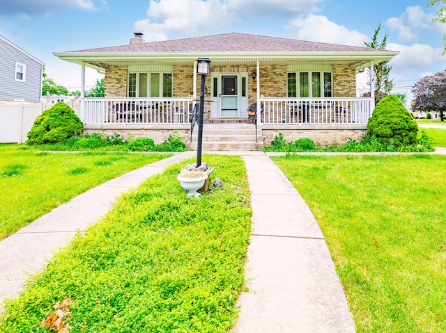 single story home featuring a porch and a front yard