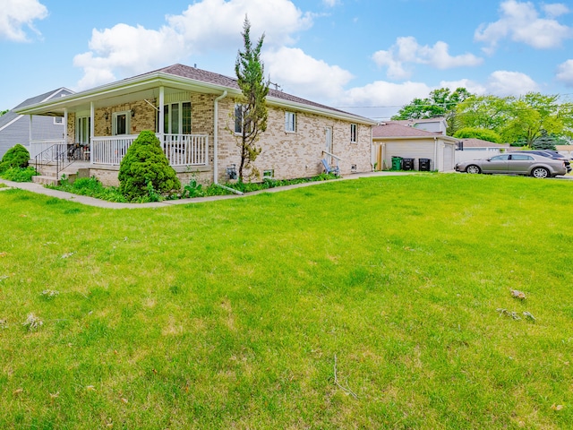 exterior space with a garage, a yard, and a porch