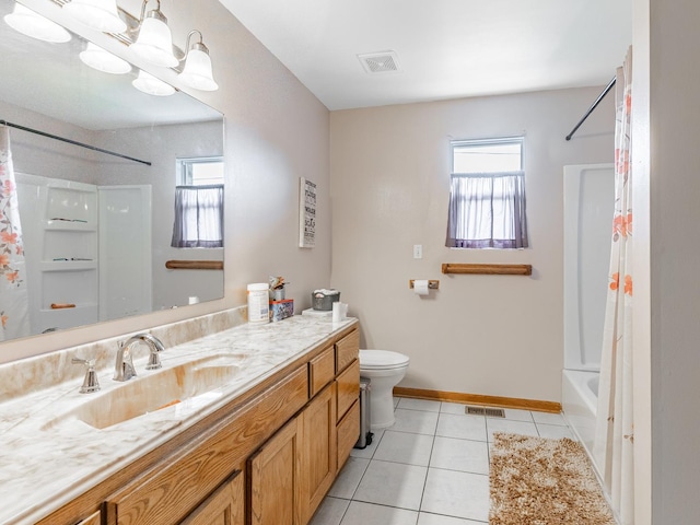 full bathroom with tile patterned flooring, vanity, toilet, and a healthy amount of sunlight