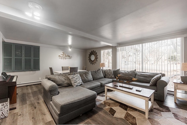 living room featuring baseboard heating and hardwood / wood-style flooring