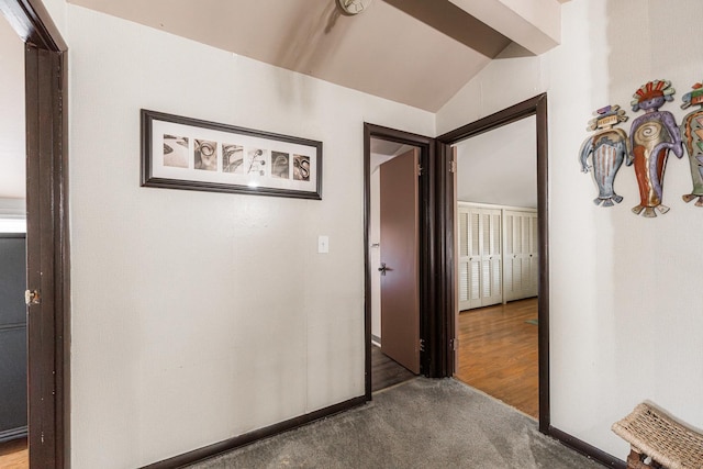 corridor featuring carpet and lofted ceiling