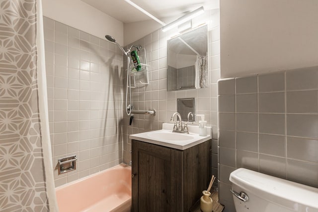 full bathroom featuring toilet, tile walls, decorative backsplash, shower / bathtub combination with curtain, and vanity