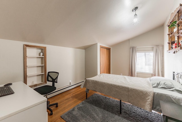 bedroom with hardwood / wood-style flooring, vaulted ceiling, and a baseboard heating unit