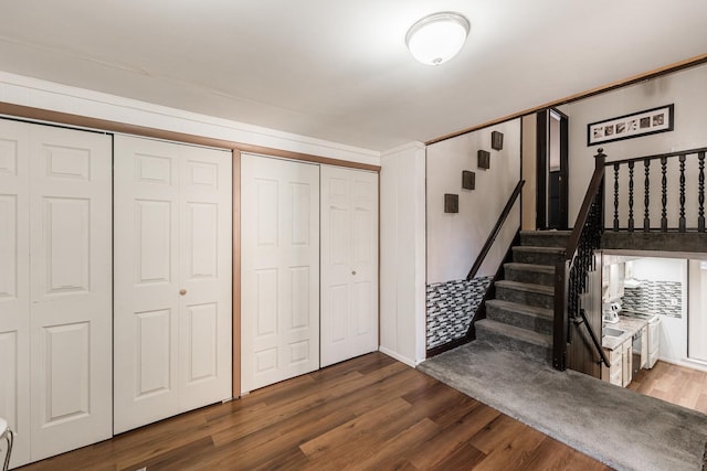 stairway with dark hardwood / wood-style flooring