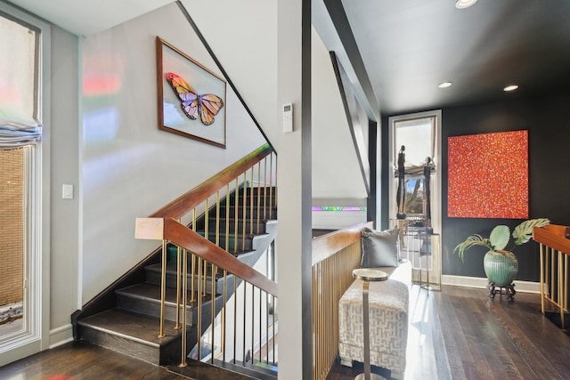 stairway with hardwood / wood-style flooring and a wealth of natural light