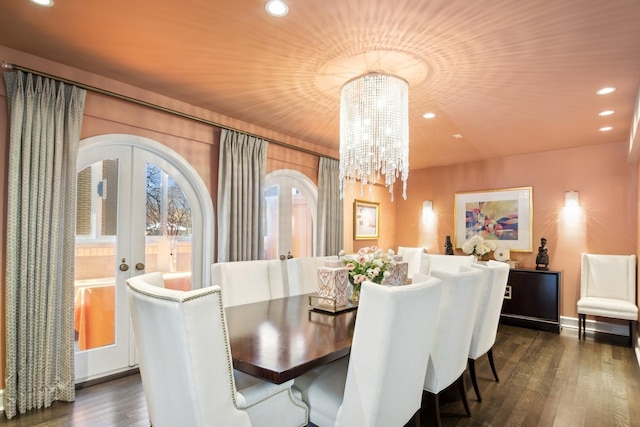 dining area featuring dark hardwood / wood-style flooring, french doors, and a chandelier