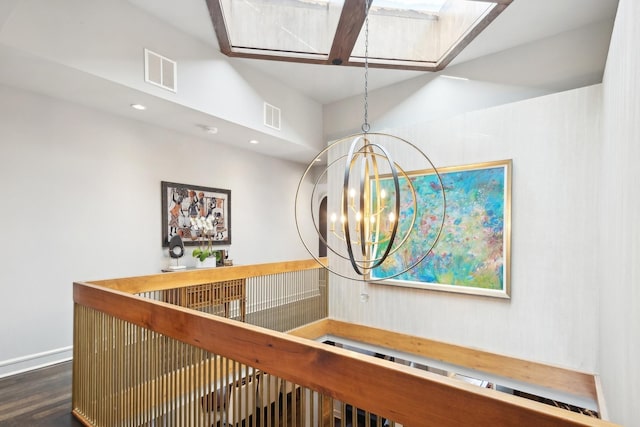 hallway featuring an inviting chandelier, a towering ceiling, and dark hardwood / wood-style floors