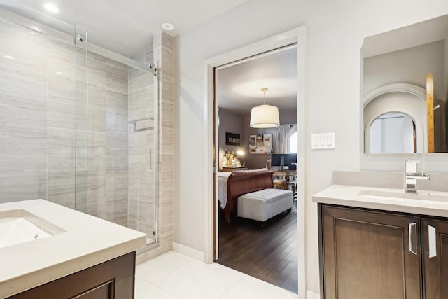 bathroom featuring an enclosed shower, vanity, and tile patterned floors