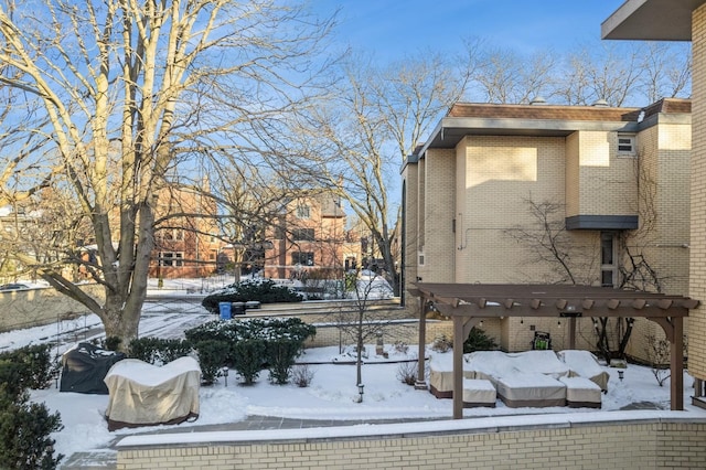 snowy yard featuring a pergola