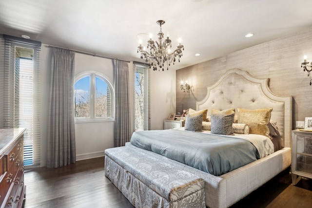 bedroom with dark hardwood / wood-style floors and a notable chandelier