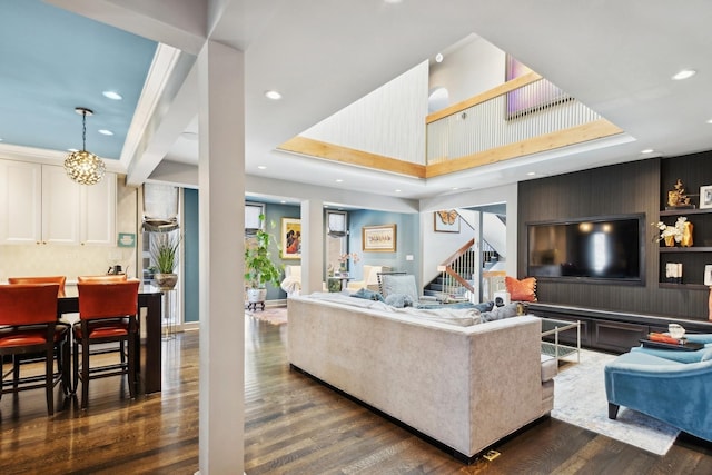 living room with an inviting chandelier and dark hardwood / wood-style floors