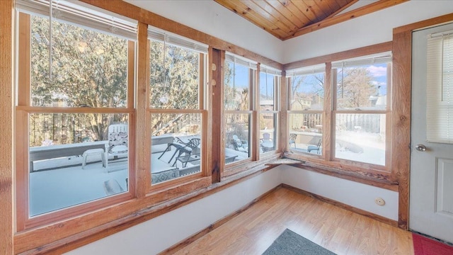 unfurnished sunroom with wood ceiling and vaulted ceiling