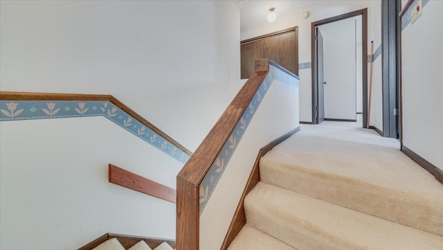 staircase with carpet and baseboards