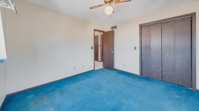 unfurnished bedroom featuring light colored carpet, a ceiling fan, baseboards, visible vents, and a closet