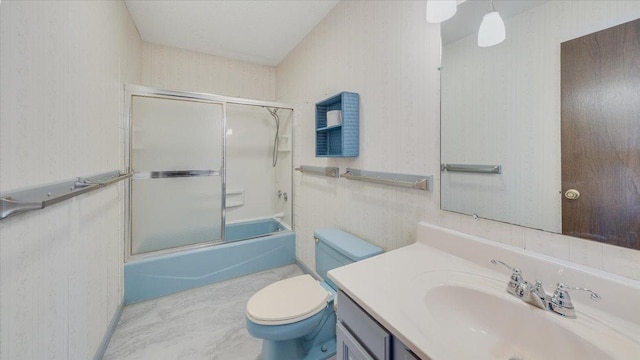 bathroom featuring bath / shower combo with glass door, vanity, toilet, and wallpapered walls