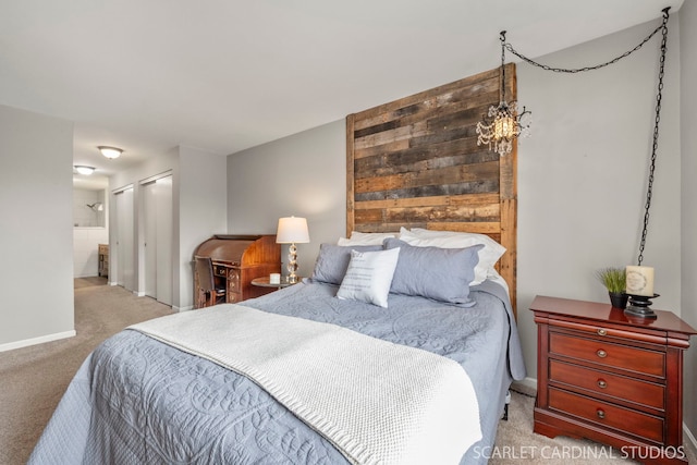 carpeted bedroom featuring ensuite bath and a closet