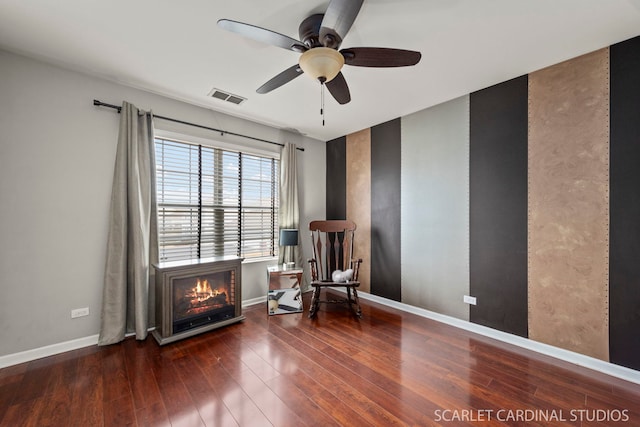 unfurnished room featuring ceiling fan, dark hardwood / wood-style flooring, and a fireplace