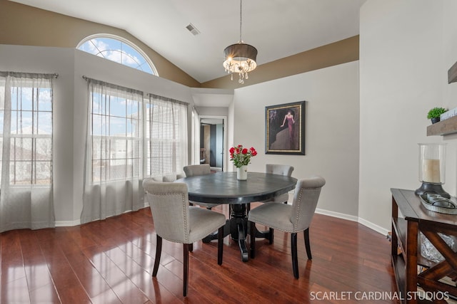 dining area with vaulted ceiling, dark wood-type flooring, and a notable chandelier