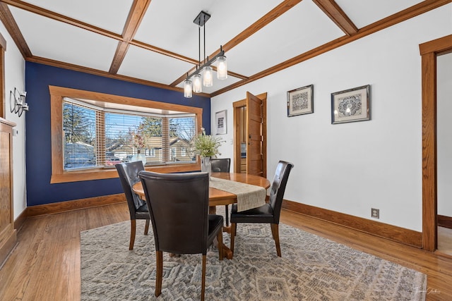 dining area featuring crown molding, coffered ceiling, hardwood / wood-style floors, and beam ceiling