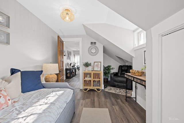 bedroom with vaulted ceiling and dark hardwood / wood-style floors