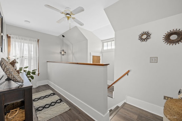 staircase featuring hardwood / wood-style flooring, vaulted ceiling, and ceiling fan