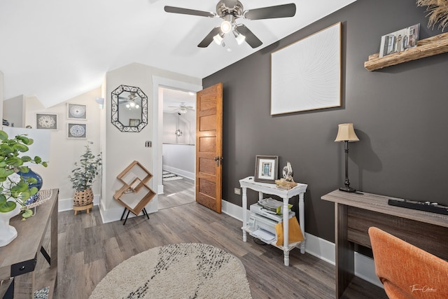 sitting room with lofted ceiling, dark hardwood / wood-style floors, and ceiling fan