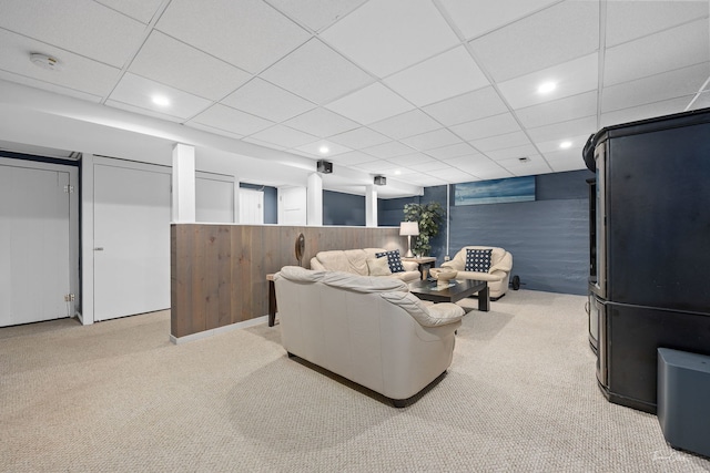 home theater room featuring light carpet and a drop ceiling