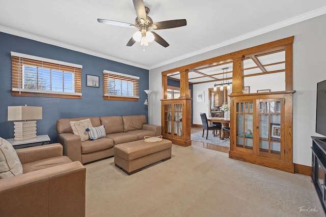 carpeted living room featuring crown molding, ceiling fan, and a healthy amount of sunlight