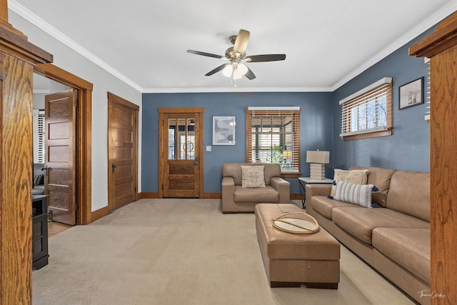 carpeted living room with crown molding and ceiling fan